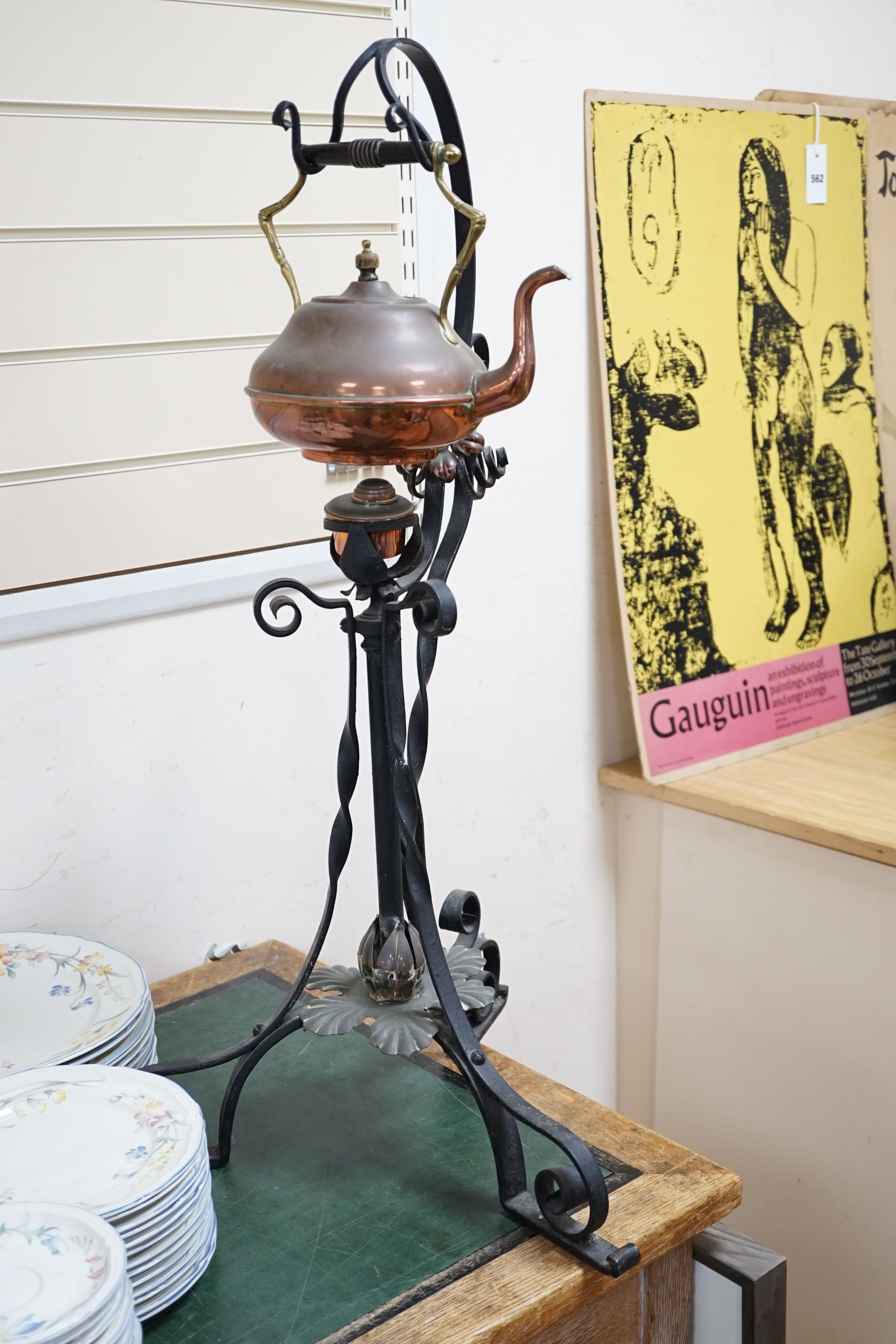 An Arts & Crafts wrought iron and copper burner stand with associated copper kettle 83cm